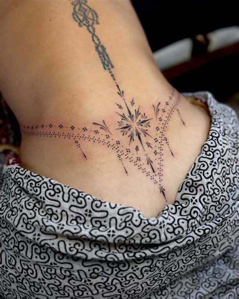 A Woman Amp 39 S Lower Back Tattoo With Birds In The Shape Of A Heart On Her A Woman Amp 39 S Lower Back Tattoo With Birds In The Shape Of A Heart On Her