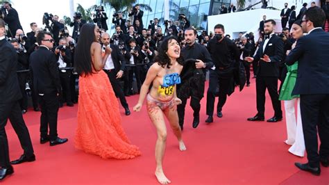 Topless Woman Removed From Cannes Red Carpet After Pro Ukraine Protest Topless Woman Removed From Cannes Red Carpet After Pro Ukraine Protest